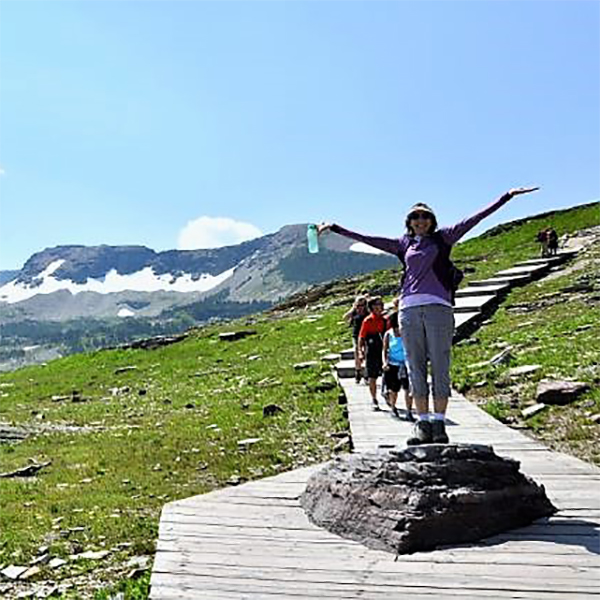 Carol poses in front of a mountain.