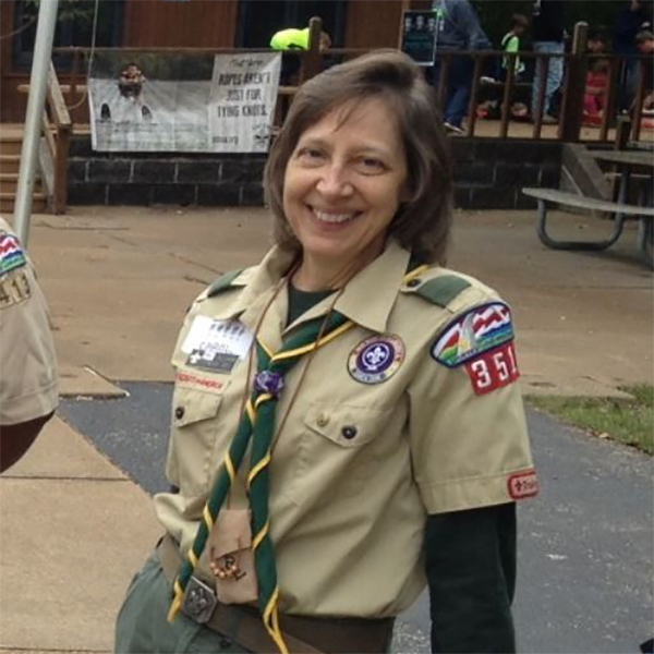 Carol smiles for the camera, wearing a scouts uniform