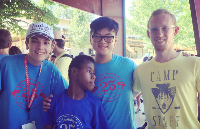 Small group posing together at camp.