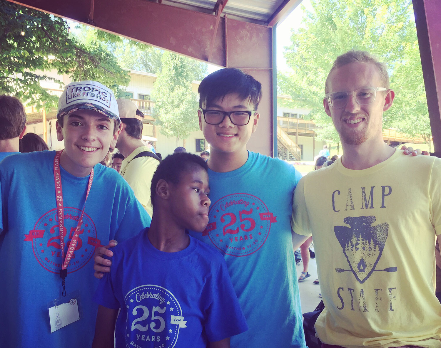 Small group posing together at camp.