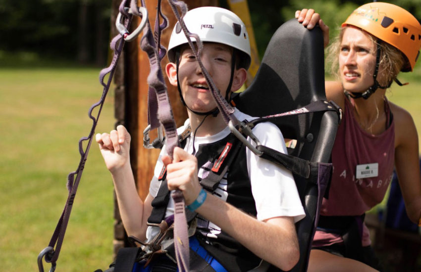 Young adult male enjoying the high ropes.