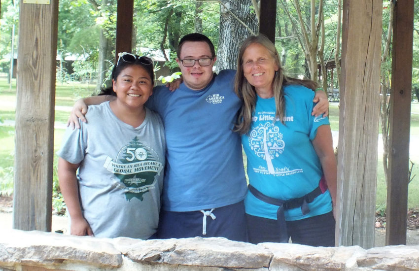 Two campers posing with female counselor