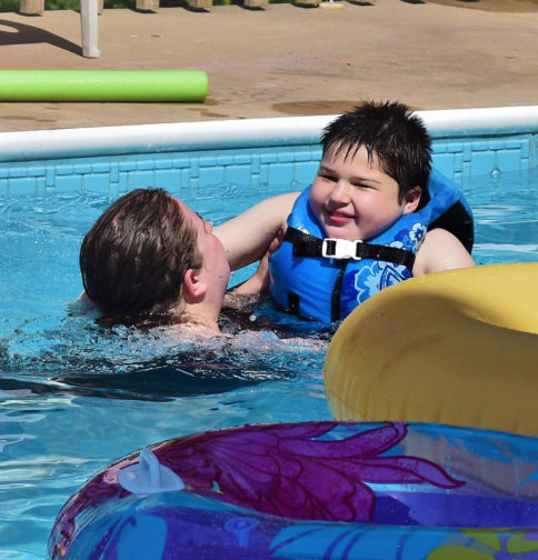 Young boy learning to swim.