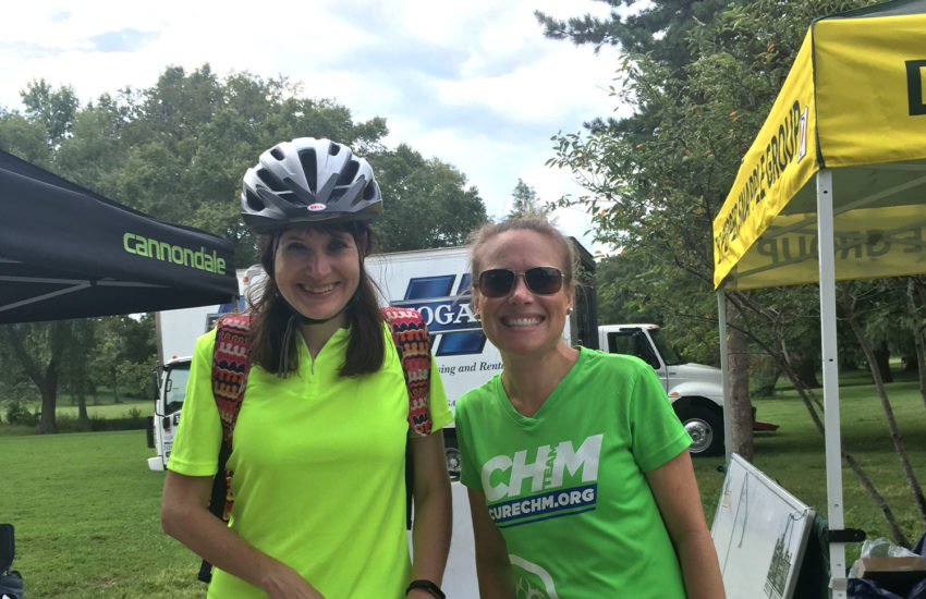 Two women smiling at a biking event.