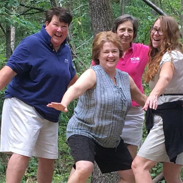 Recreation Council staff stand in the woods, posing for the camera.